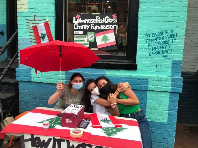 L to R: Susan Hammoud, Christina Limansky and Karla Stephan sit outside of Muncheez, DC gathering donations to support the Lebanese Red Cross.