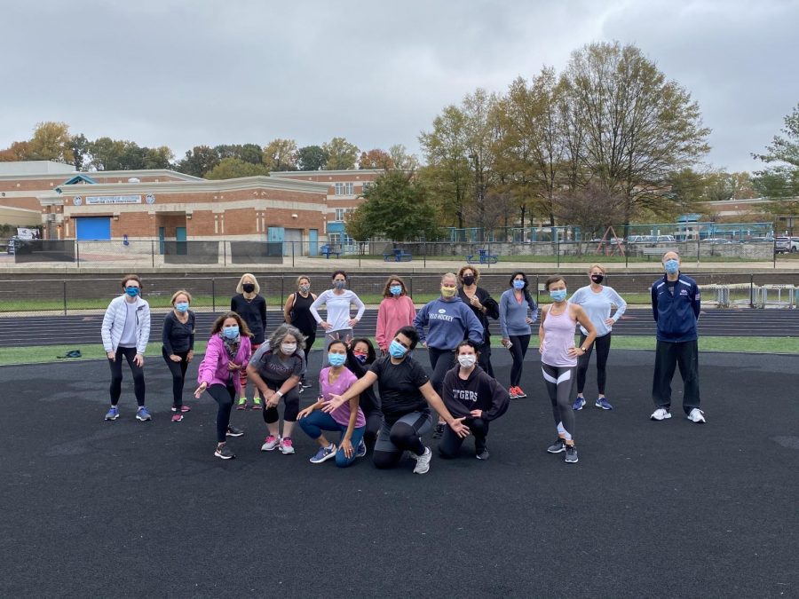 Members of the Zumba class pose for a photo on the Whitman track. 