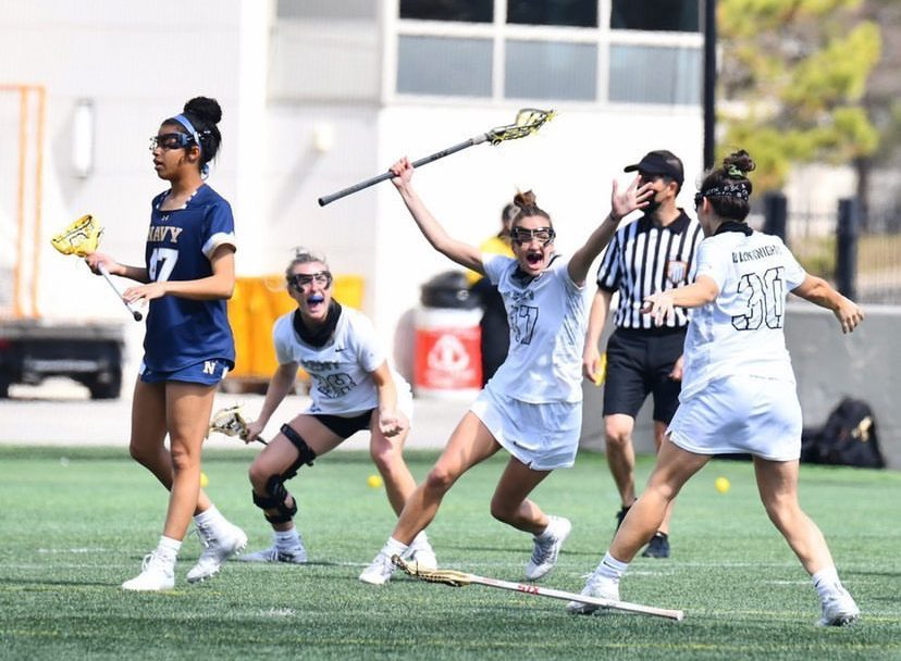 Cadet Carleigh Armstrong (47), who graduated from The Academy of the Holy Cross (20), celebrates during a Westpoint Lacrosse game.