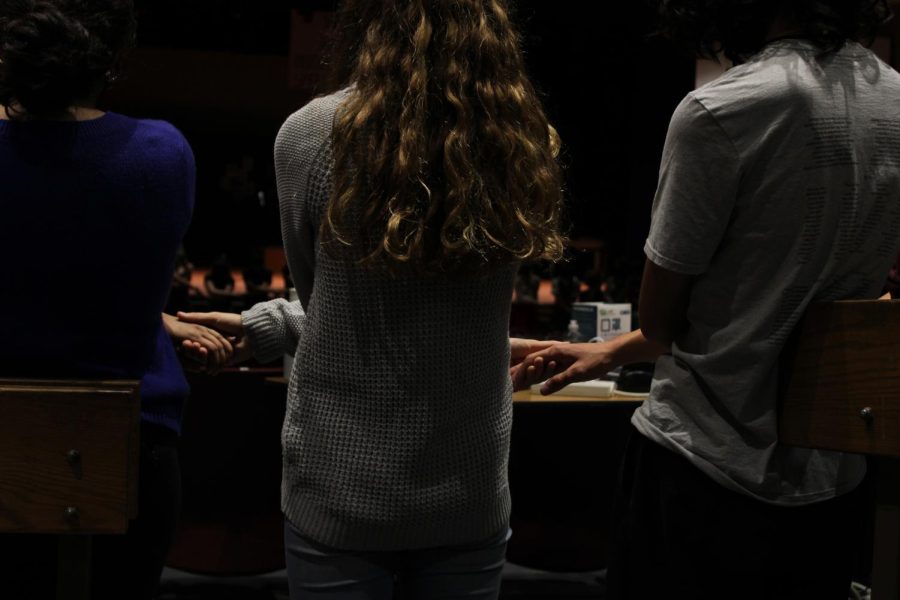 Cast and crew hold hands as part of a recurring tradition before the show.
