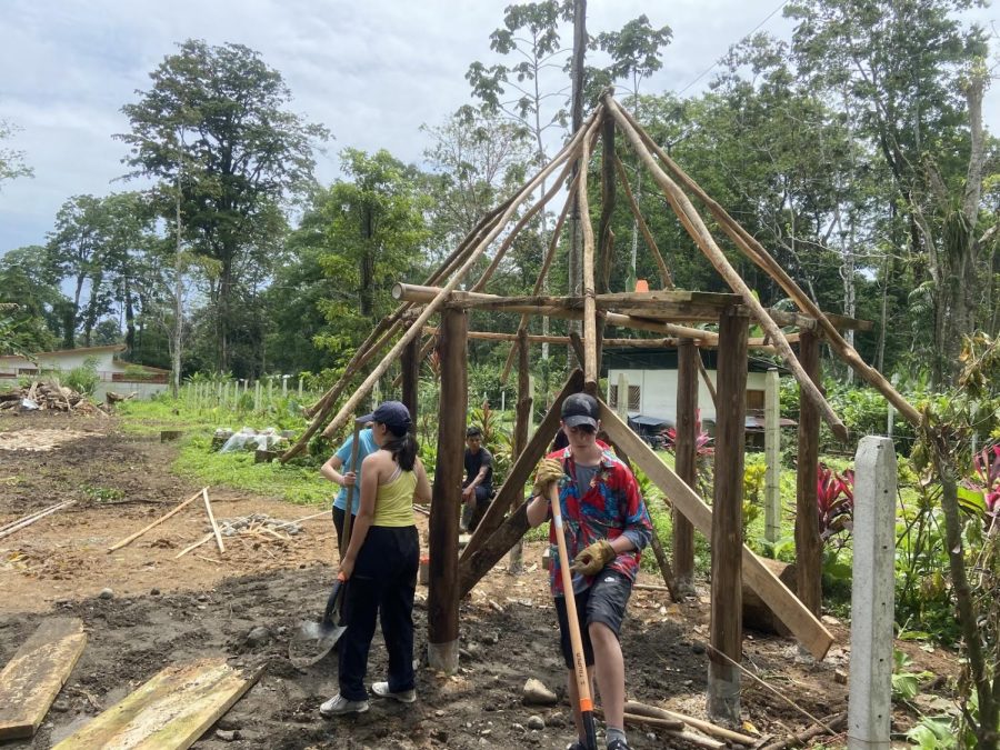 Whitman students Mitra Hu-Henderson and George Surgenor help construct a hut.