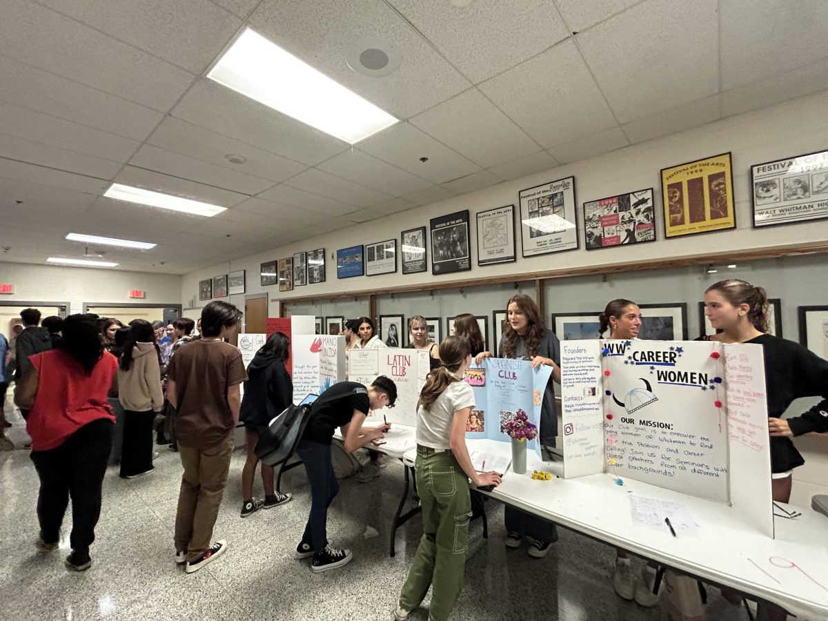 Student leaders set up tables with decorated tri-fold posters, many of which featured QR codes and sign-up notebooks for students to register easily. 