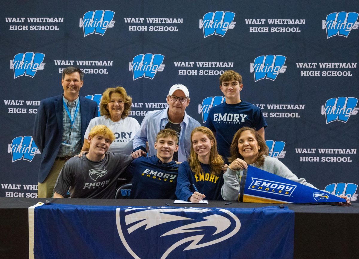 Committed athletes pose for photos with family, coaches at Signing Day.